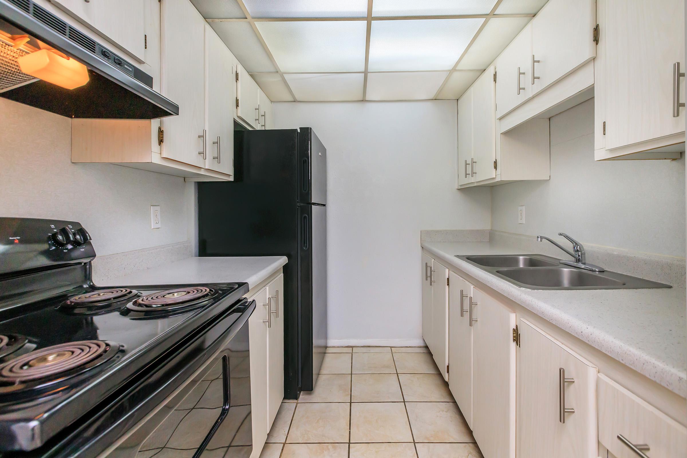 a stove top oven sitting inside of a kitchen