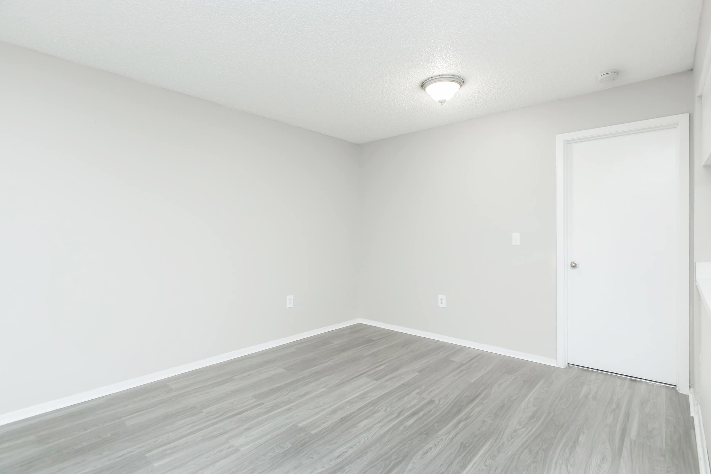 a bedroom with a wooden floor