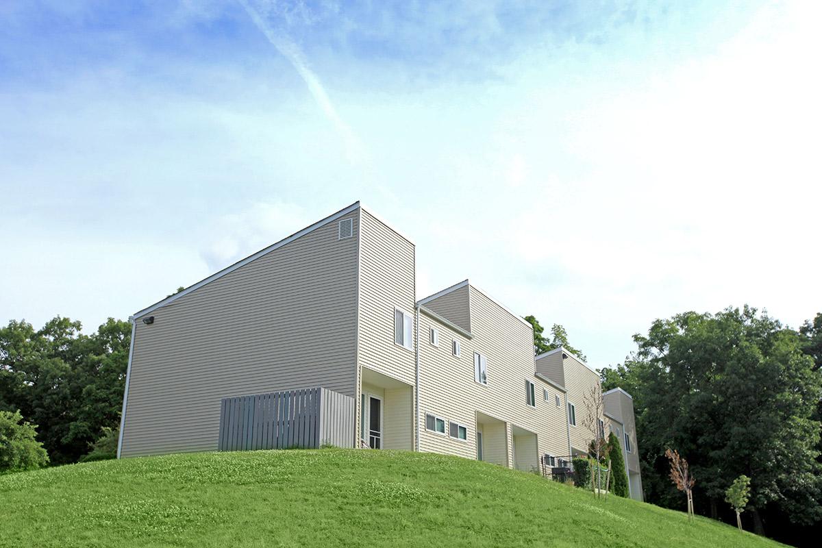 a large green field in front of a house