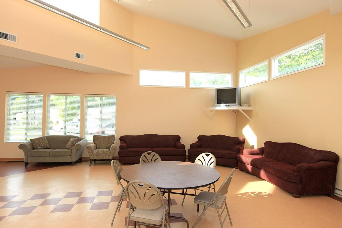 a living room filled with furniture and a large window