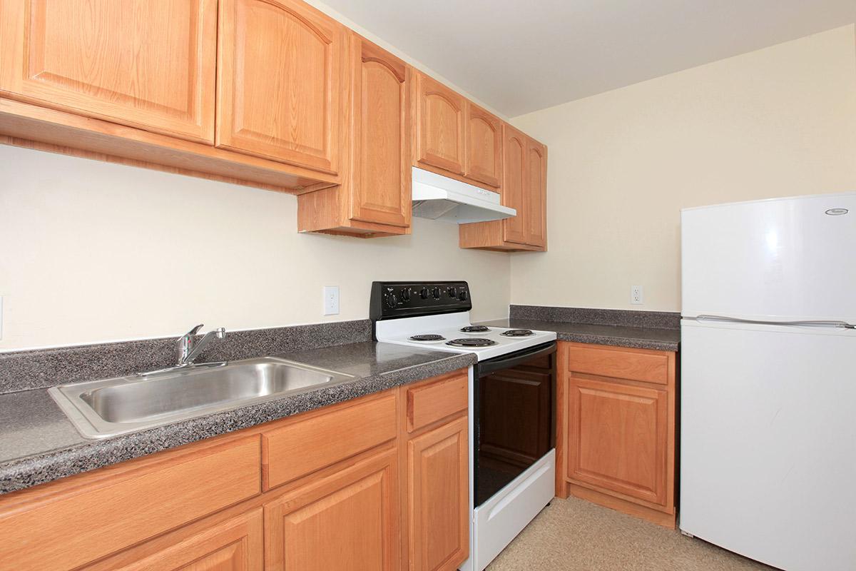 a kitchen with stainless steel appliances and wooden cabinets