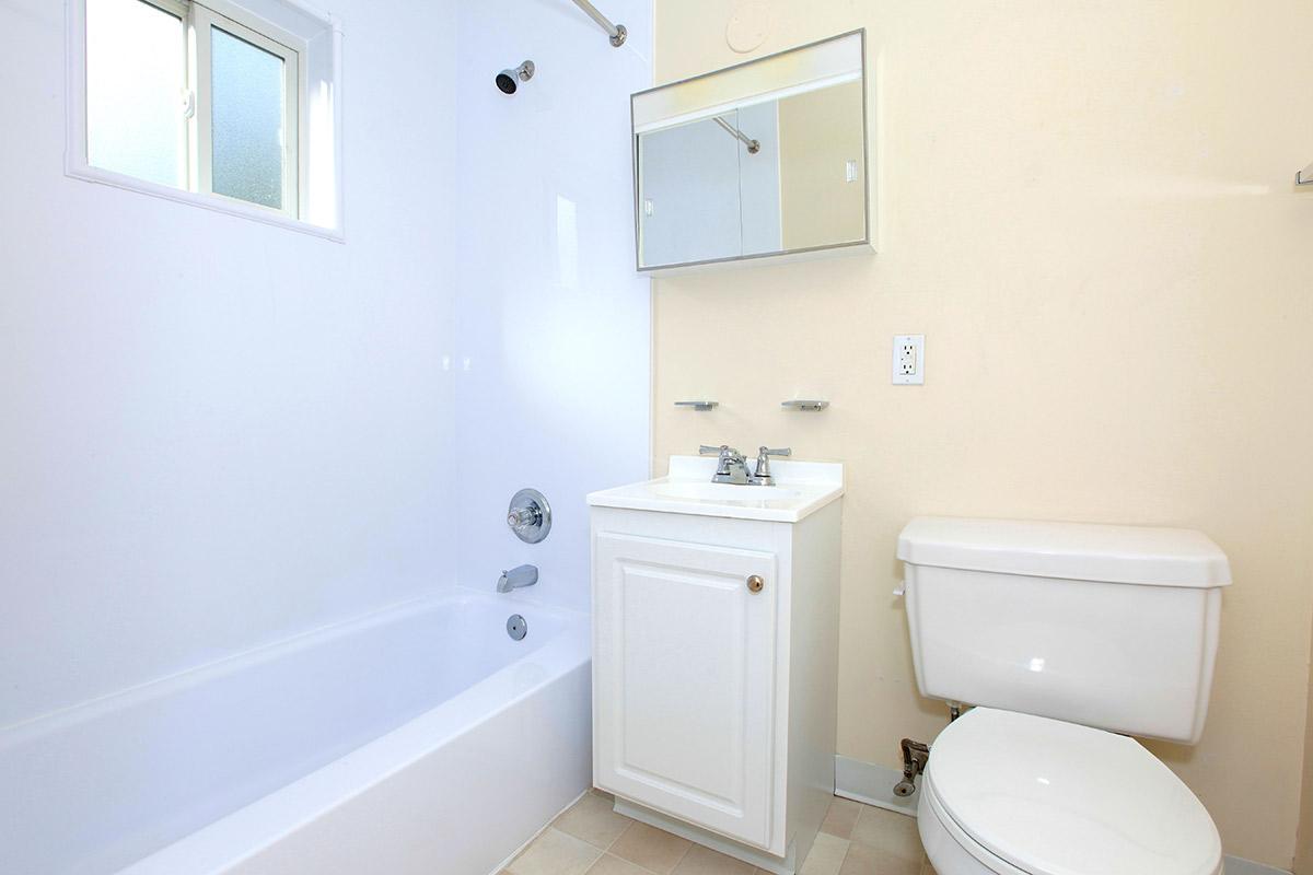 a white sink sitting next to a shower