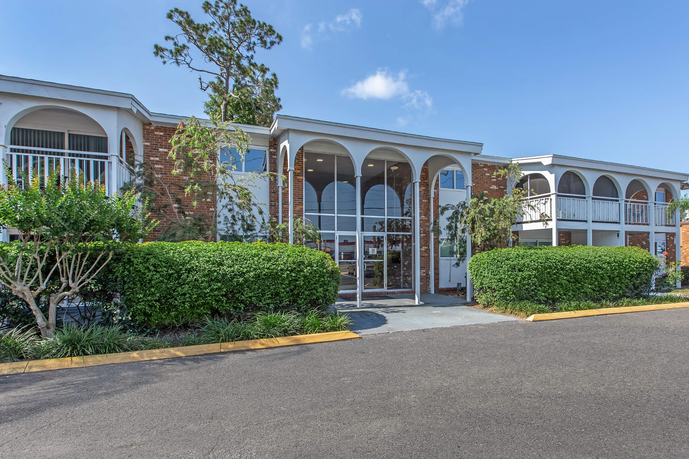 a house with bushes in front of a building