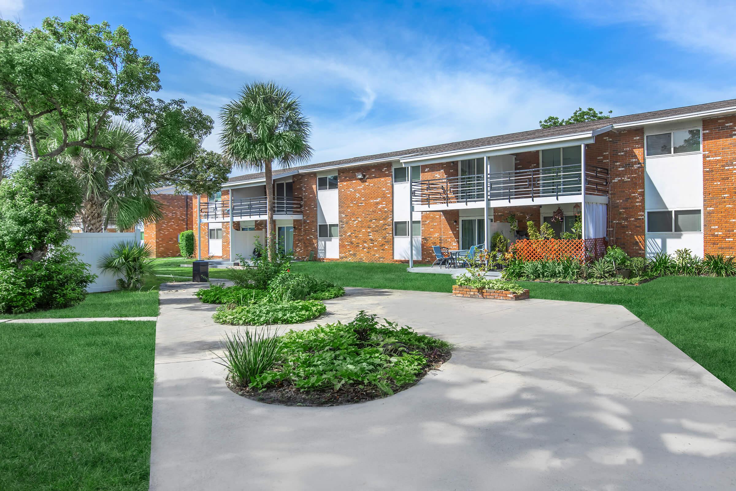 a large lawn in front of a brick building