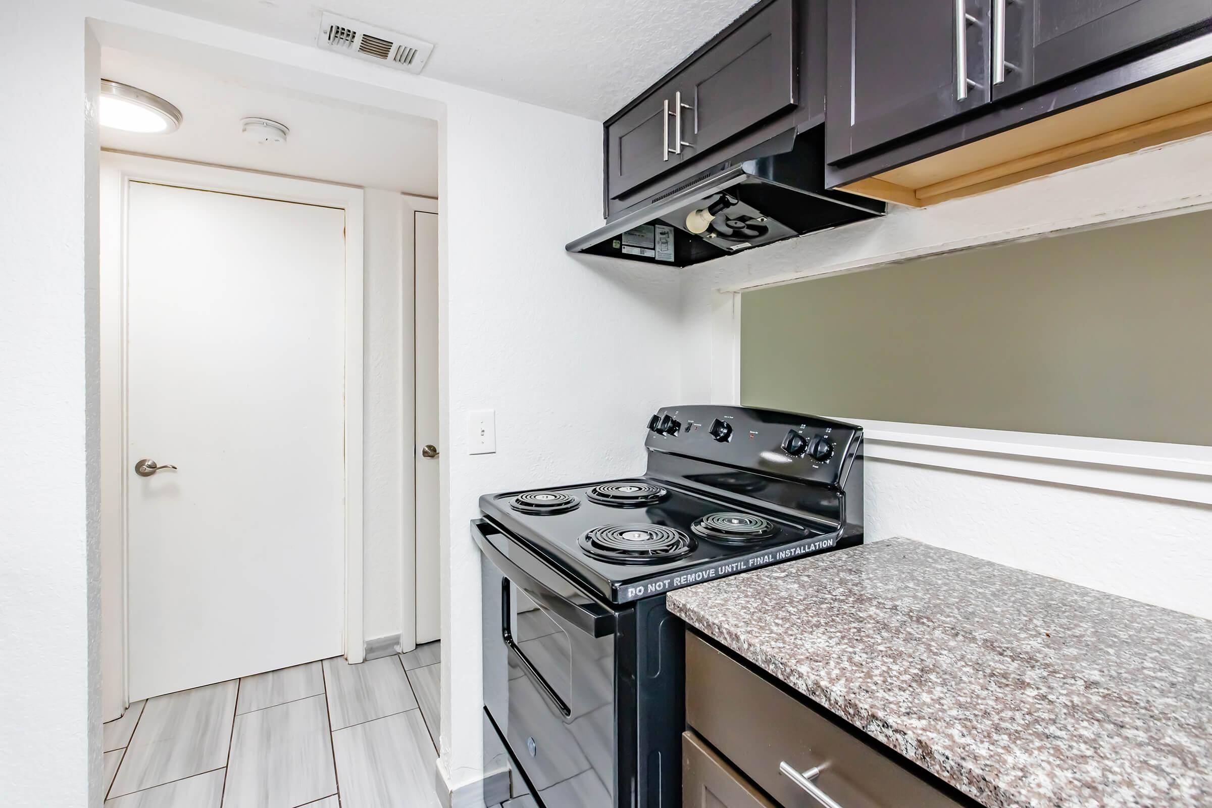 a kitchen with a stove top oven