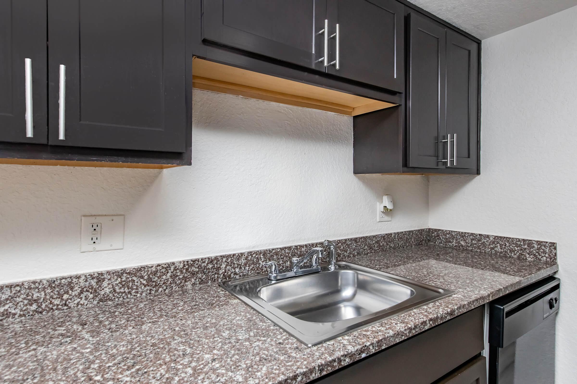 a kitchen with a sink and a microwave