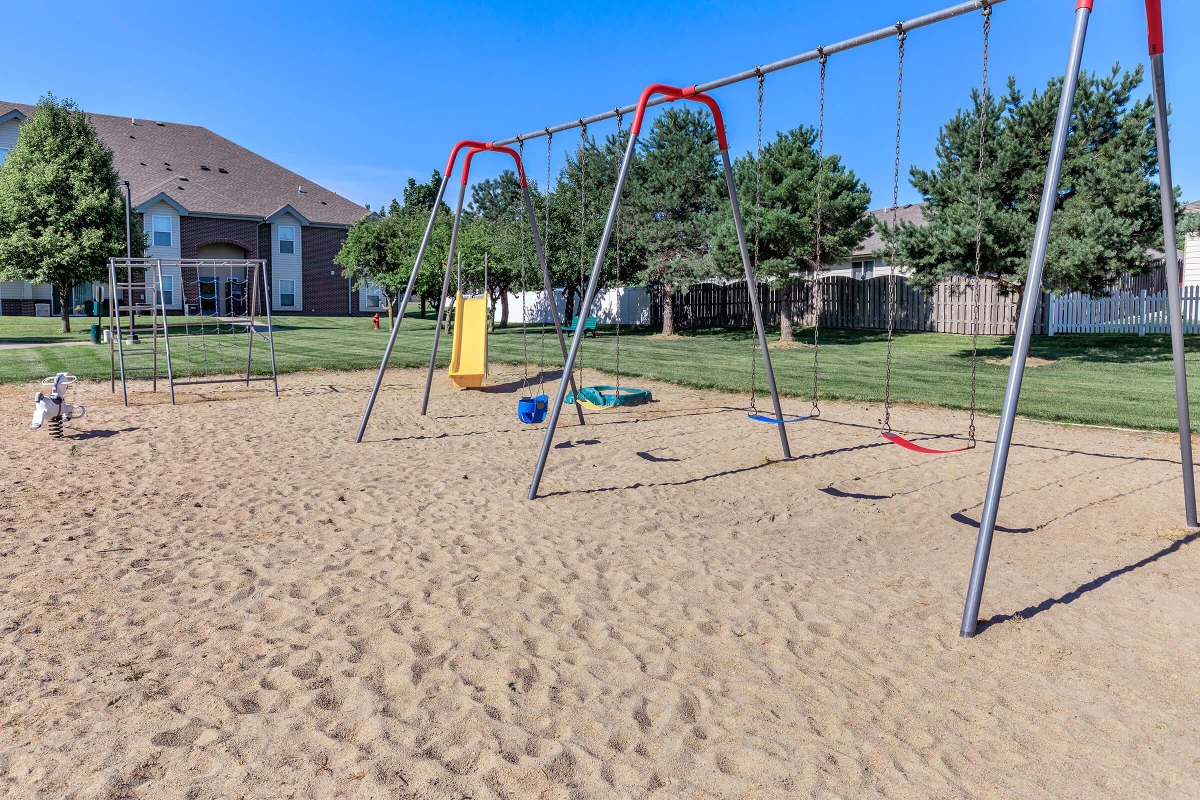 a playground in the sand on a swing