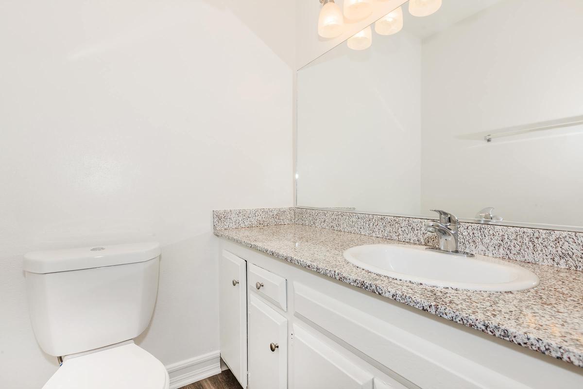 Unfurnished bathroom with white cabinets