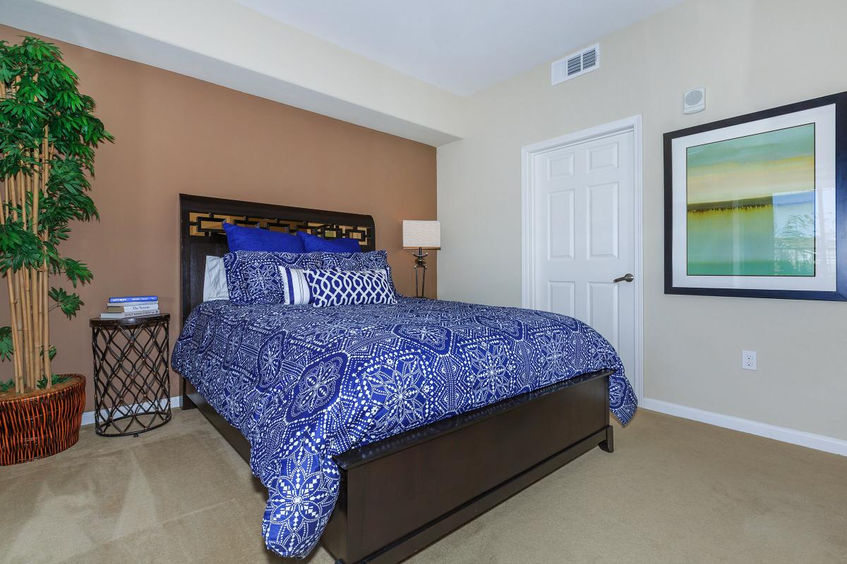 a blue and white bed in a room