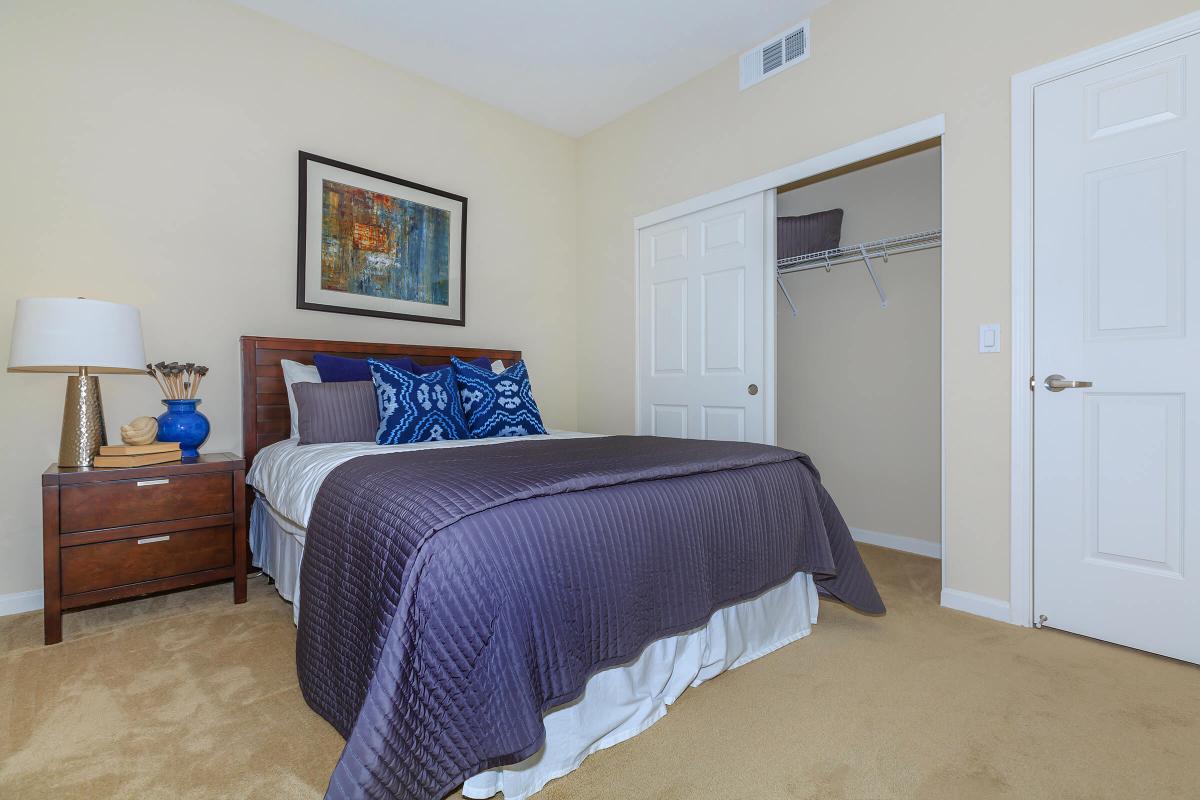 a bedroom with a bed and desk in a room