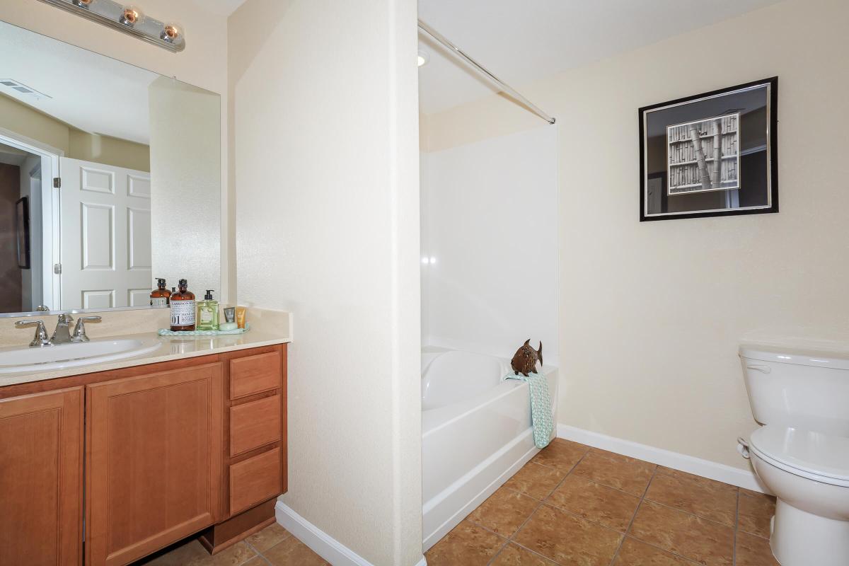 a large white tub next to a sink