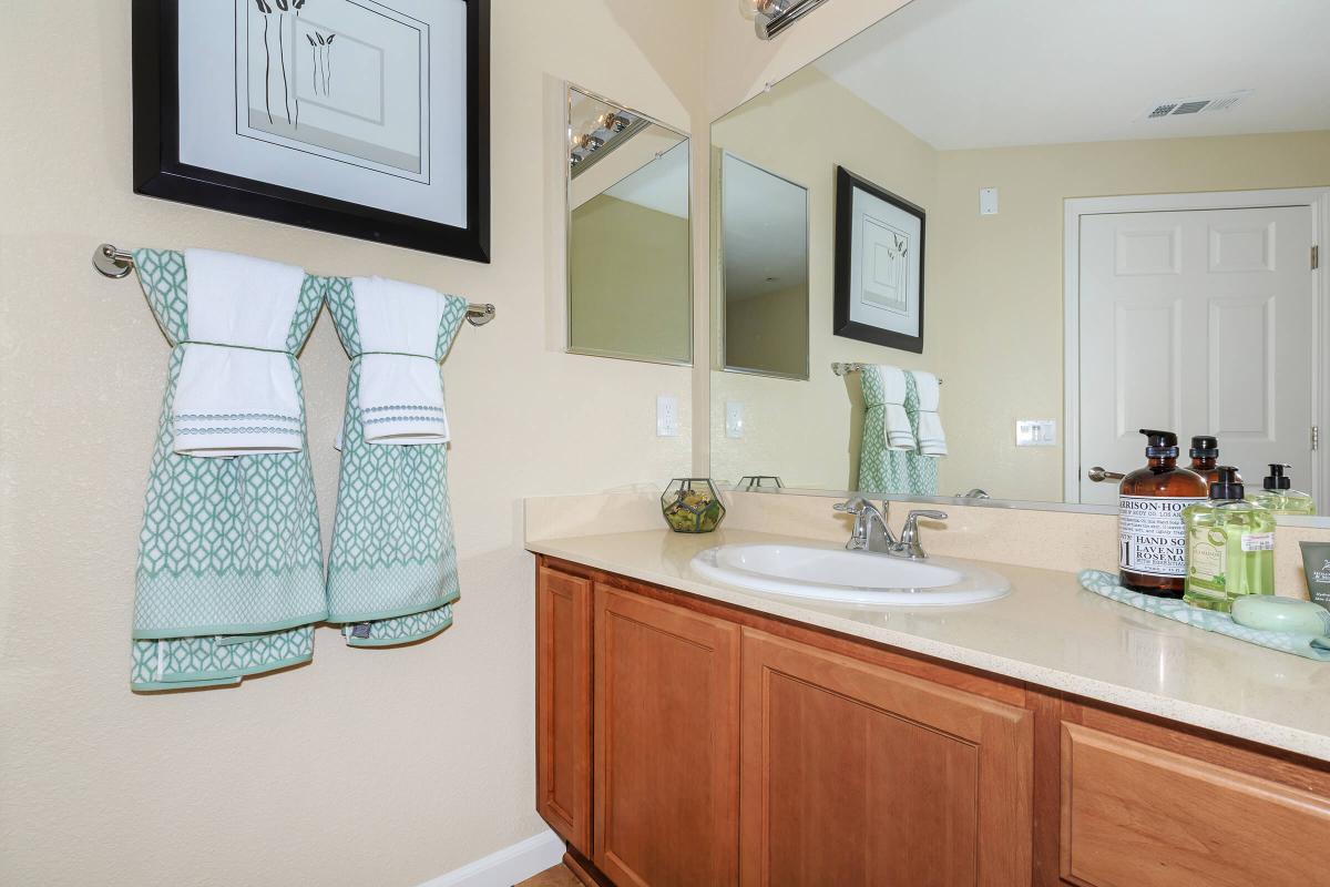 a kitchen with a sink and a mirror