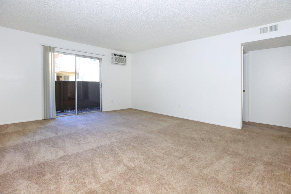 Carpeted living room with glass sliding doors