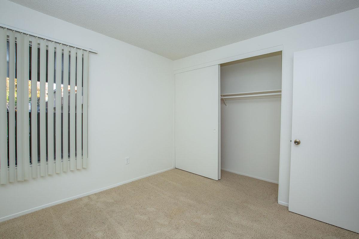 Unfurnished bedroom with open sliding closet door