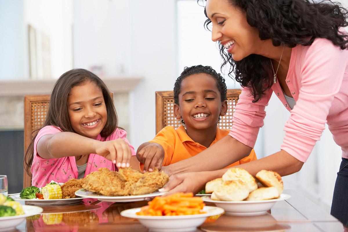Alana Ethridge sitting at a table with a plate of food