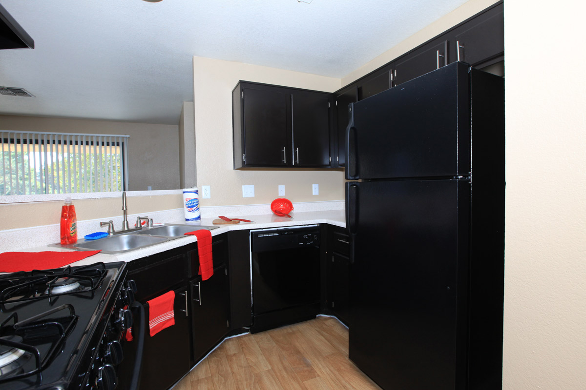 a black stove top oven sitting inside of a kitchen