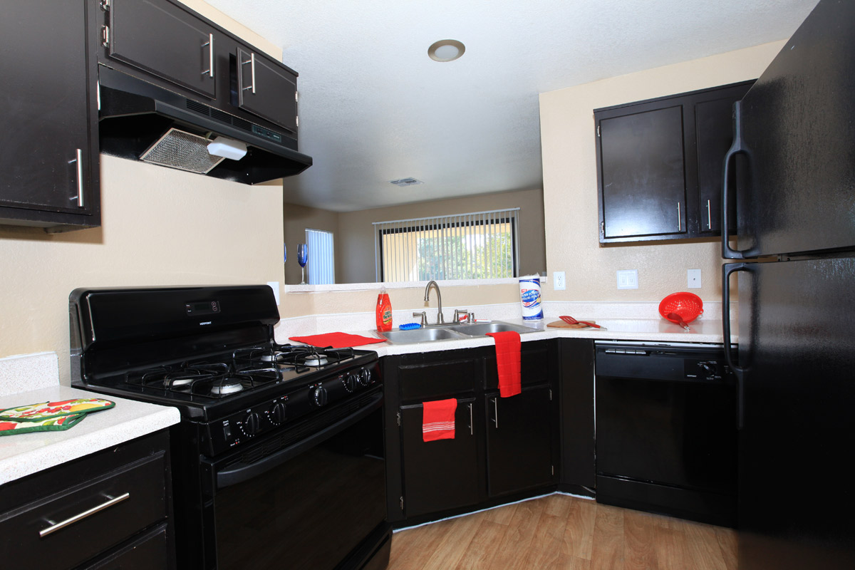 a black stove top oven sitting inside of a kitchen