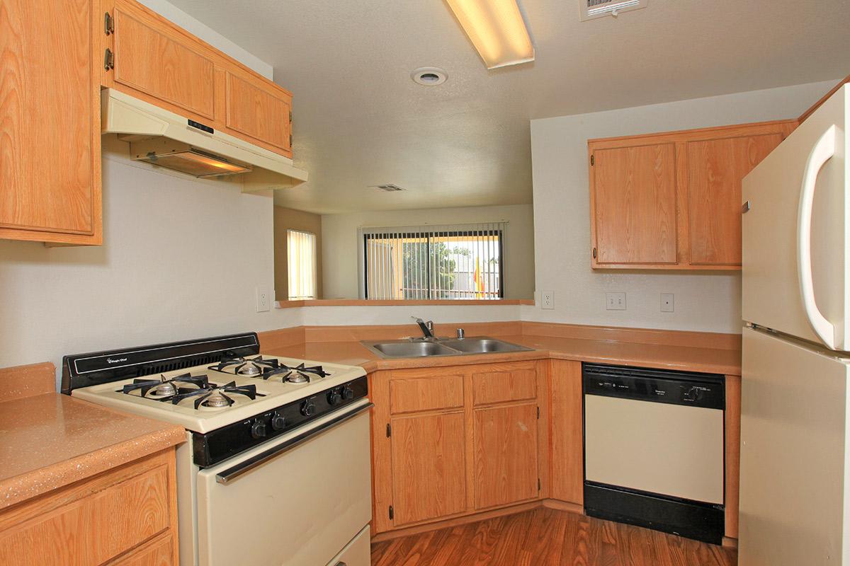 a kitchen with wooden cabinets and a black stove top oven