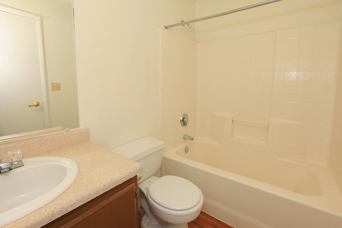 a white tub sitting next to a sink