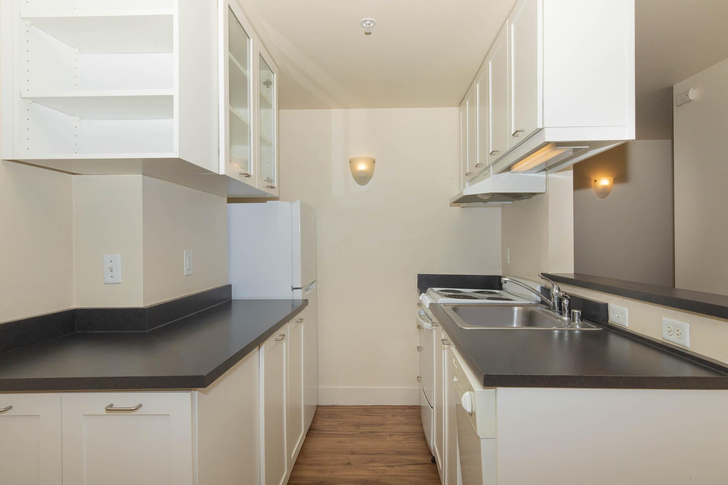 a kitchen with a sink and a refrigerator