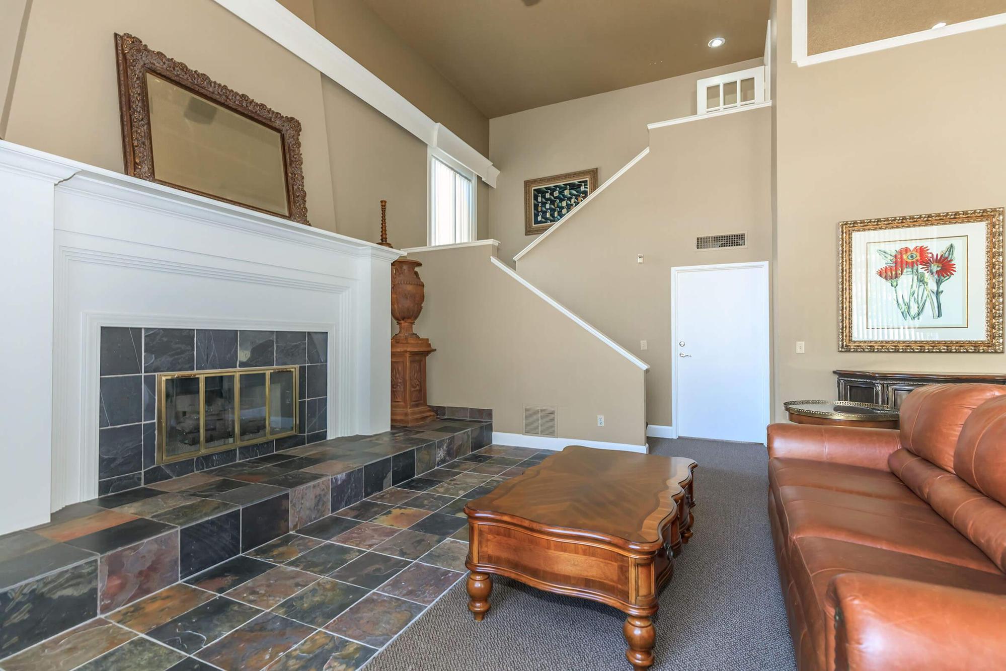 a living room filled with furniture and a fireplace