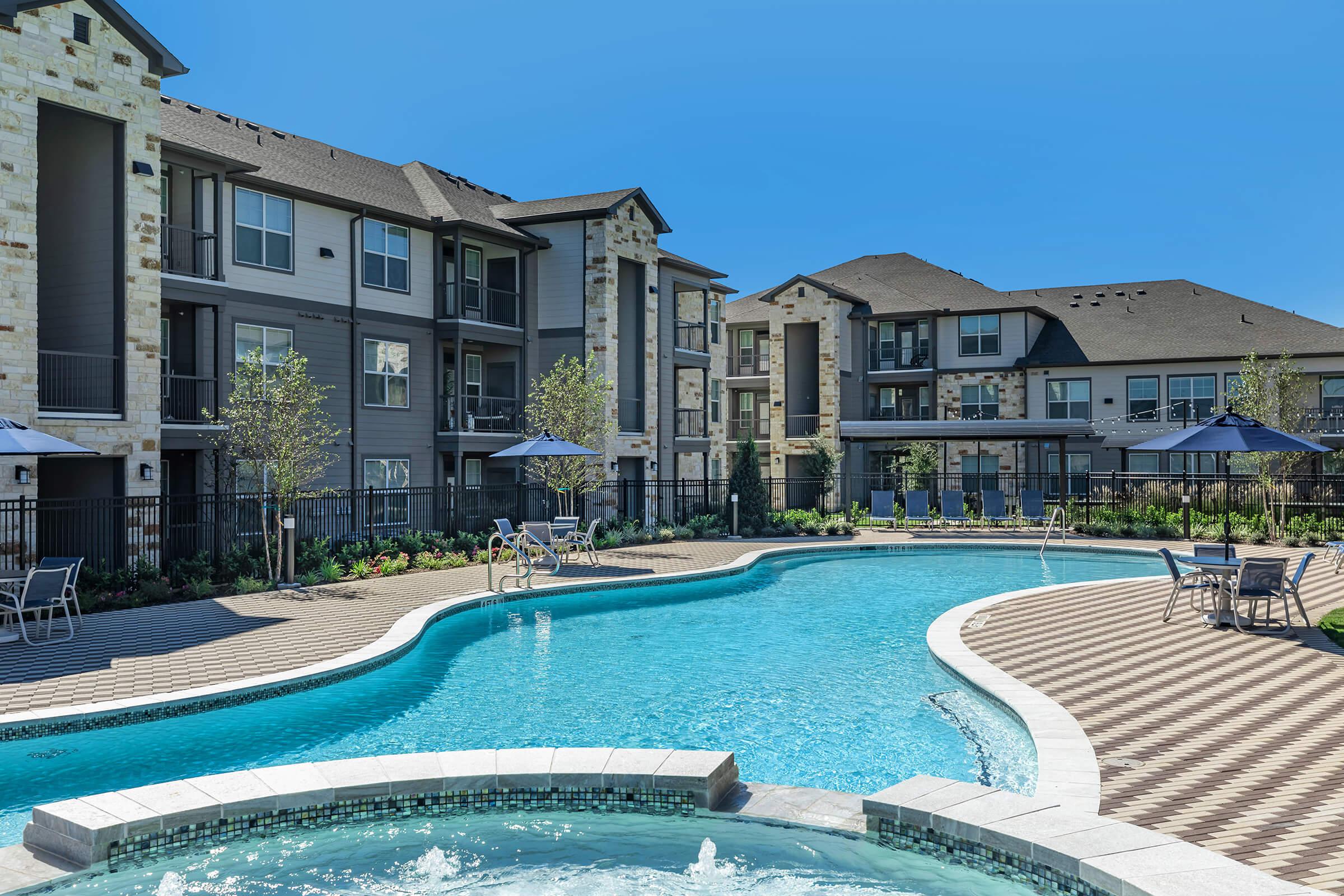 a house with a pool in front of a building