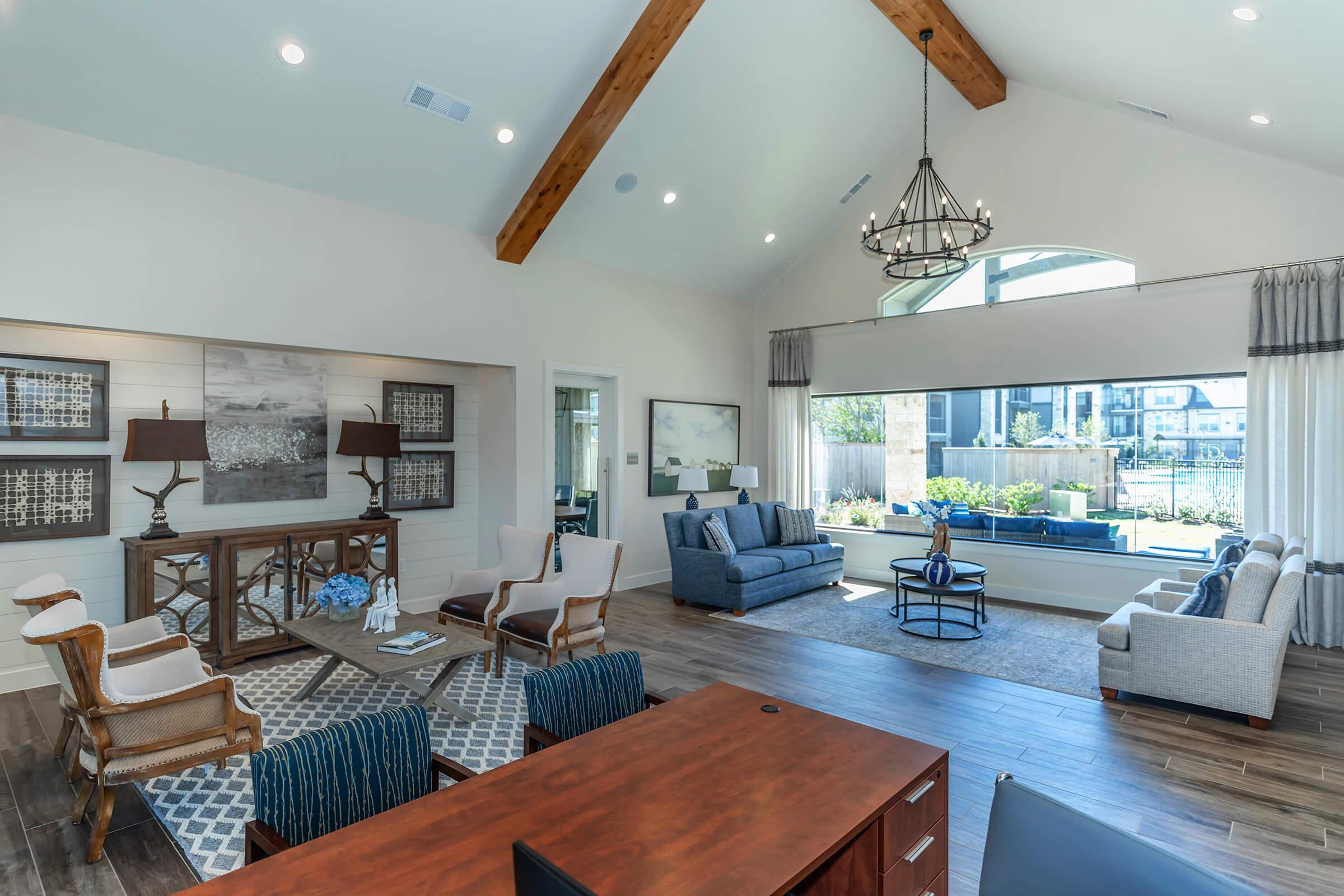 a living room filled with furniture and a large window