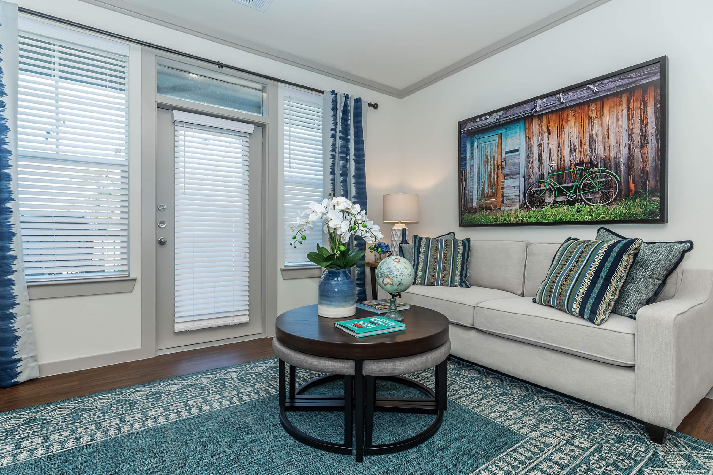 a living room filled with furniture and a large window