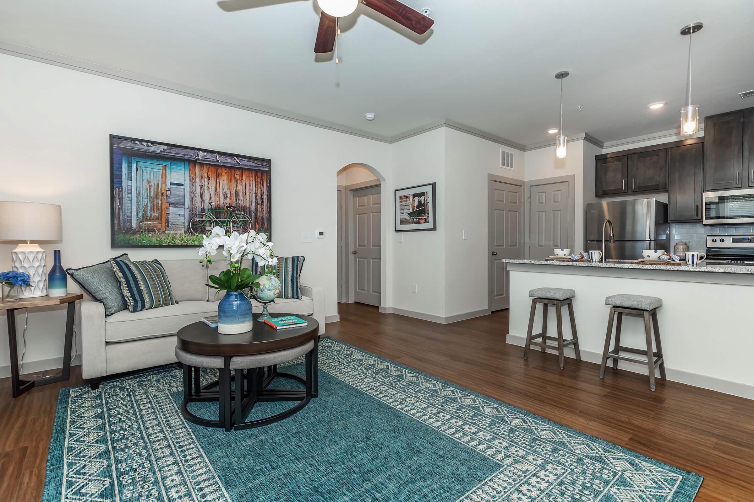 a living room filled with furniture and a rug