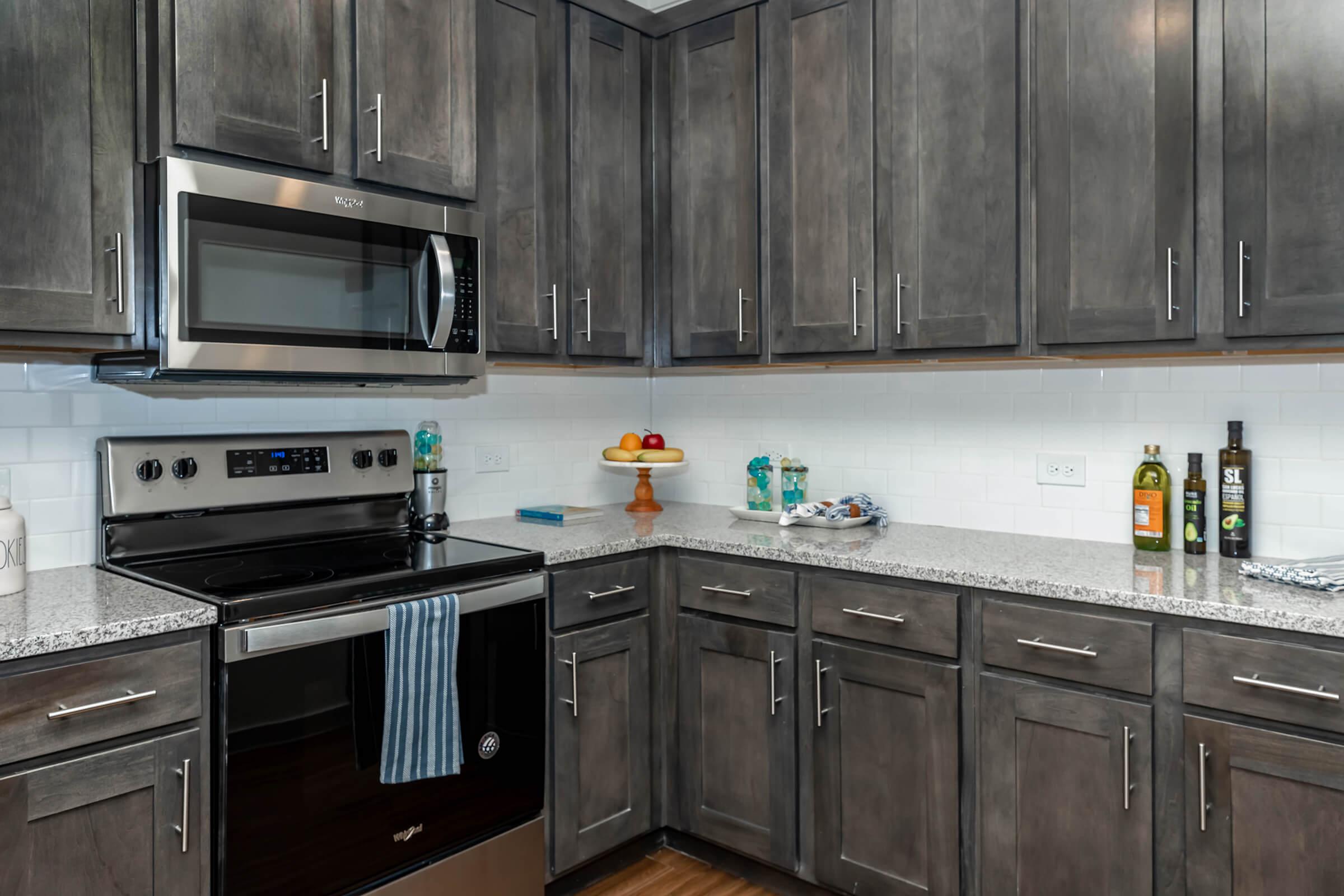 a kitchen with stainless steel appliances and wooden cabinets