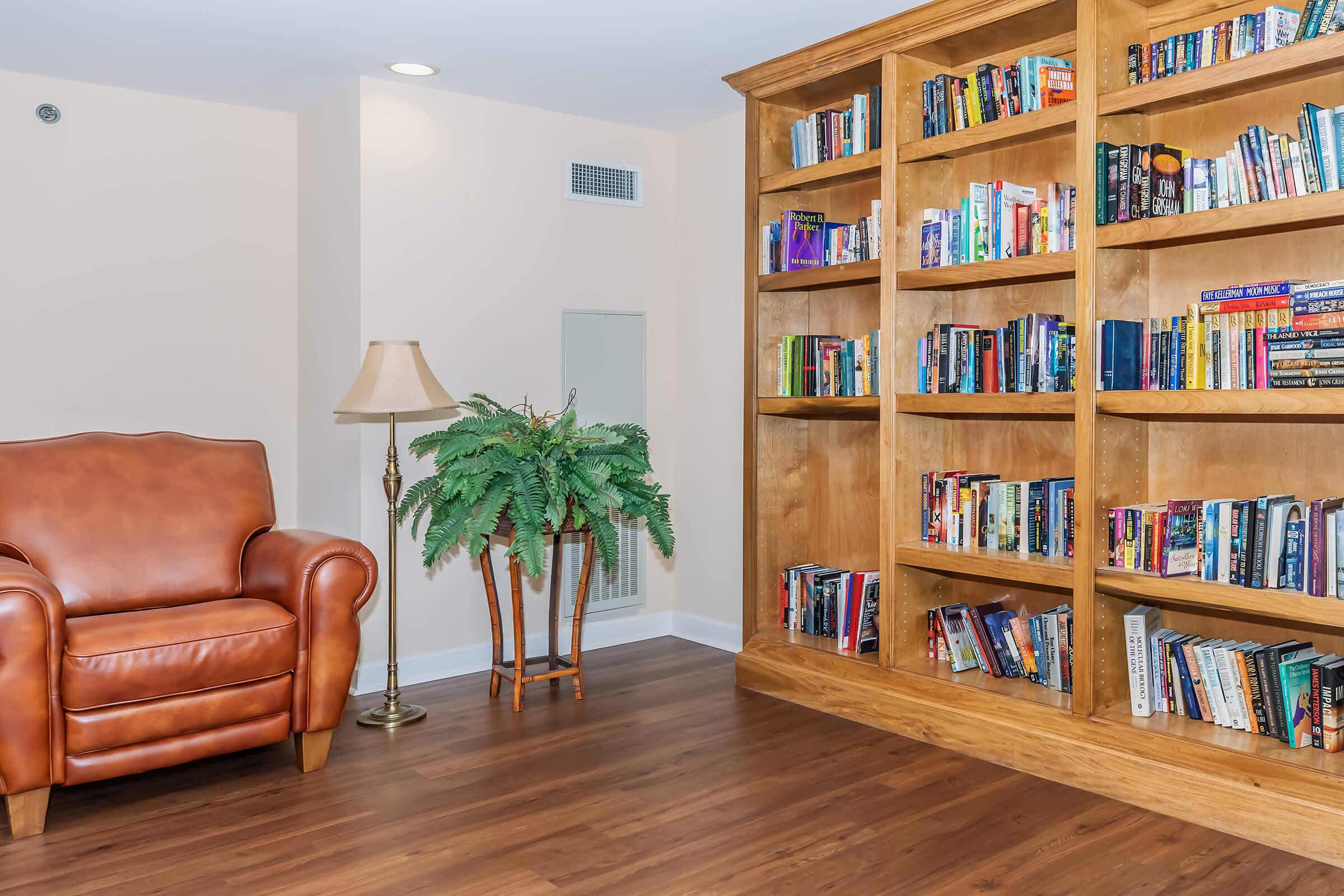 a living room filled with furniture and a book shelf