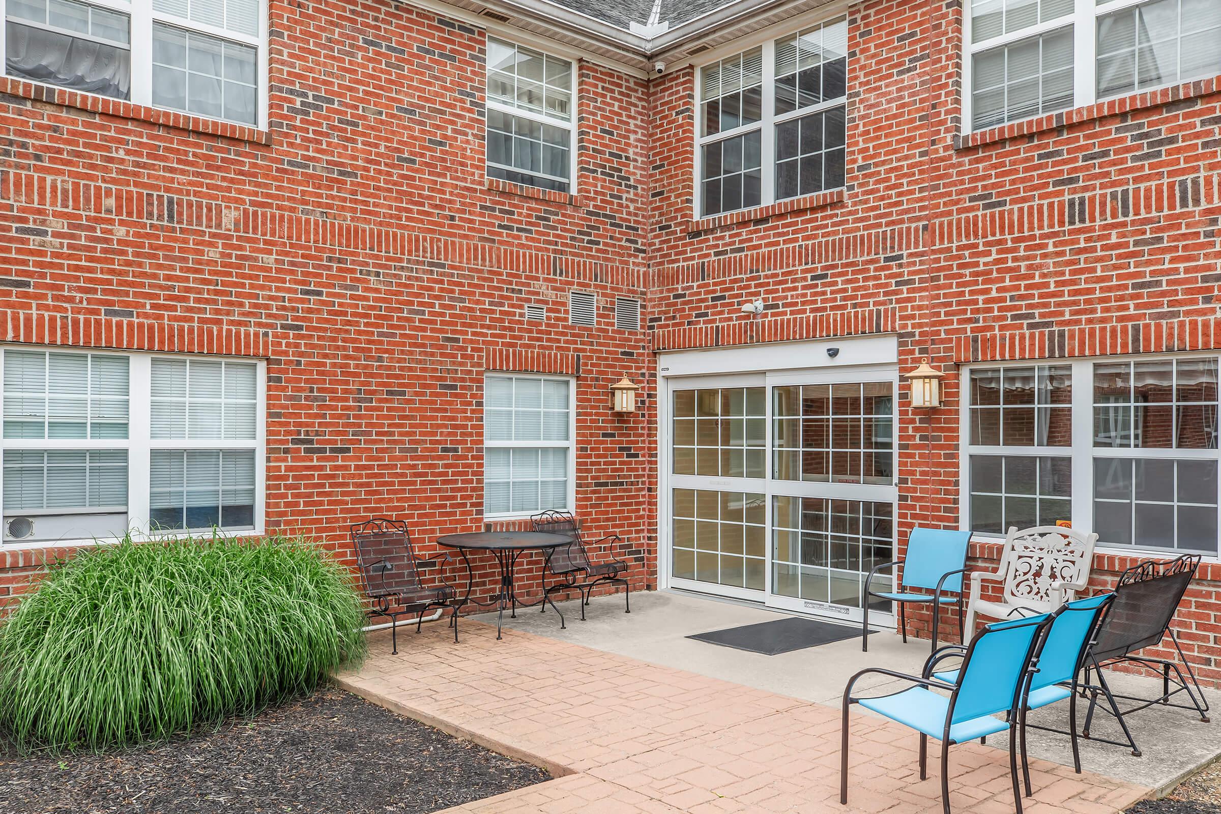 a bench in front of a brick building