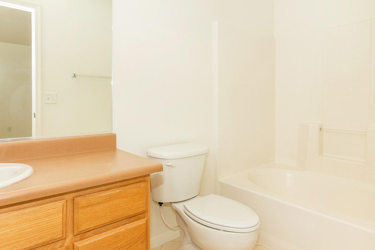 a white tub sitting next to a sink