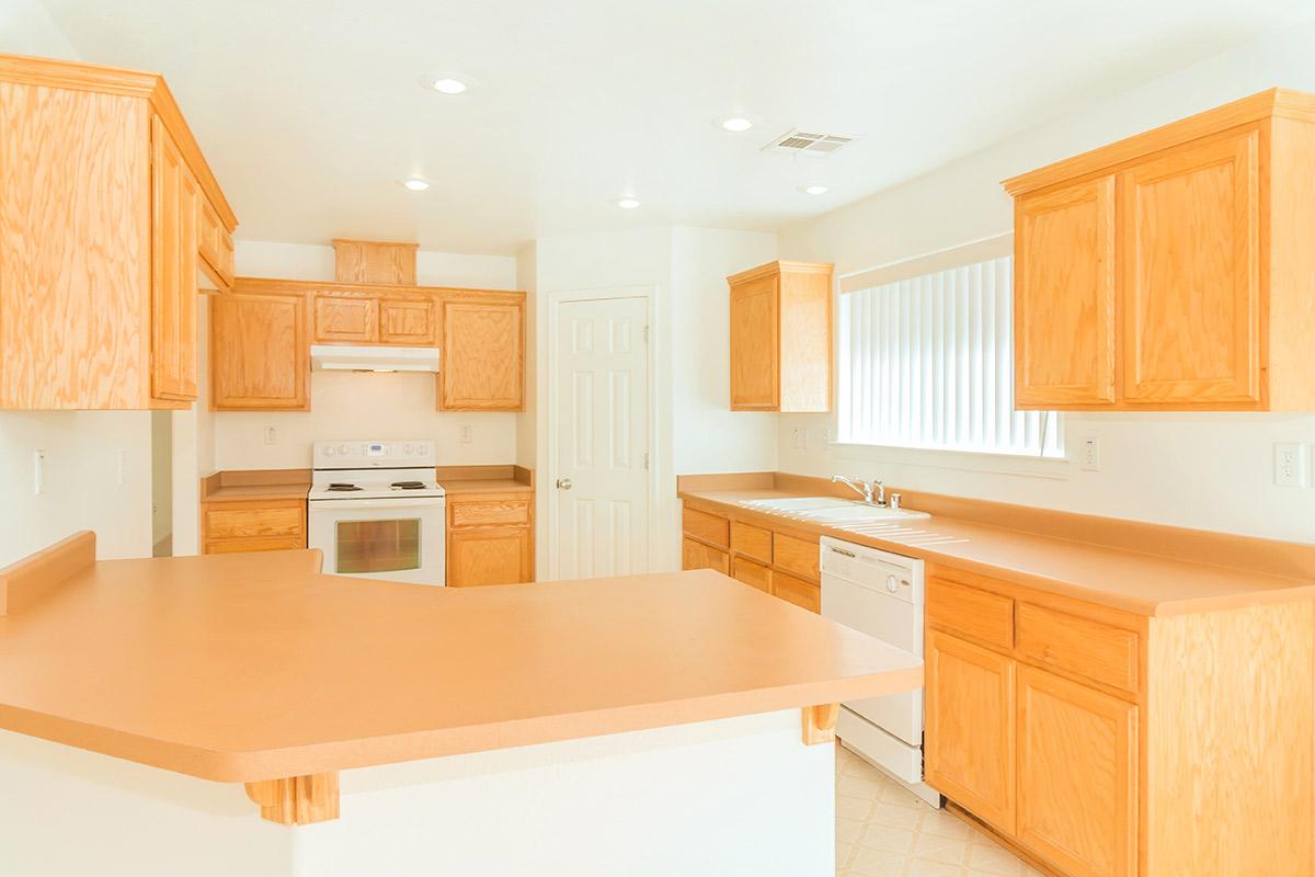 a kitchen with wooden cabinets