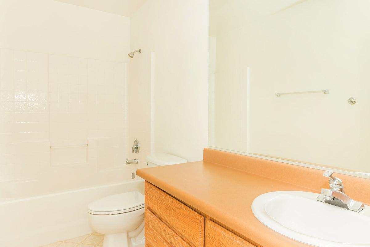 a white tub sitting next to a sink