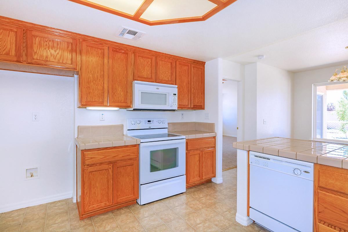 a kitchen with a stove and a refrigerator