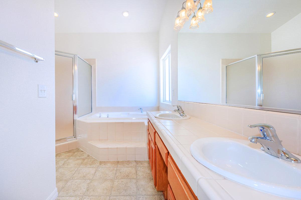 a large white tub next to a sink