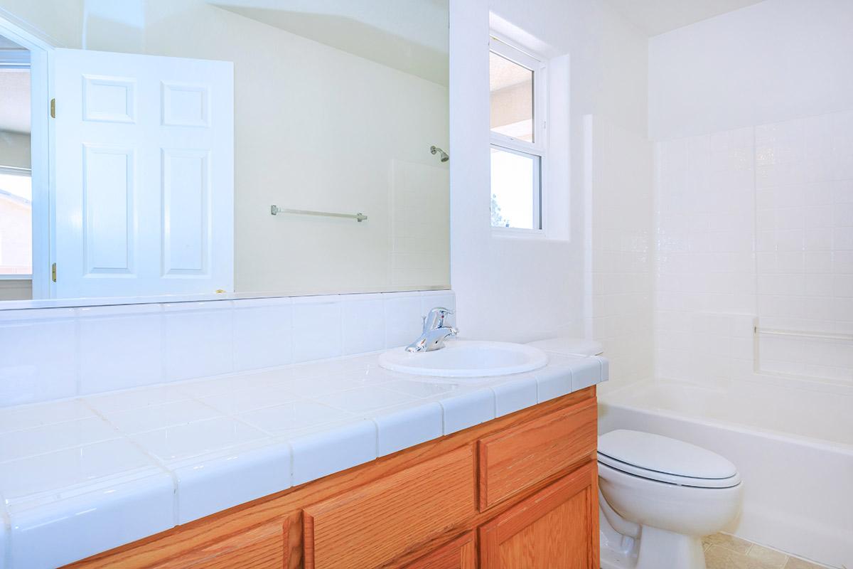 a large white tub sitting next to a sink