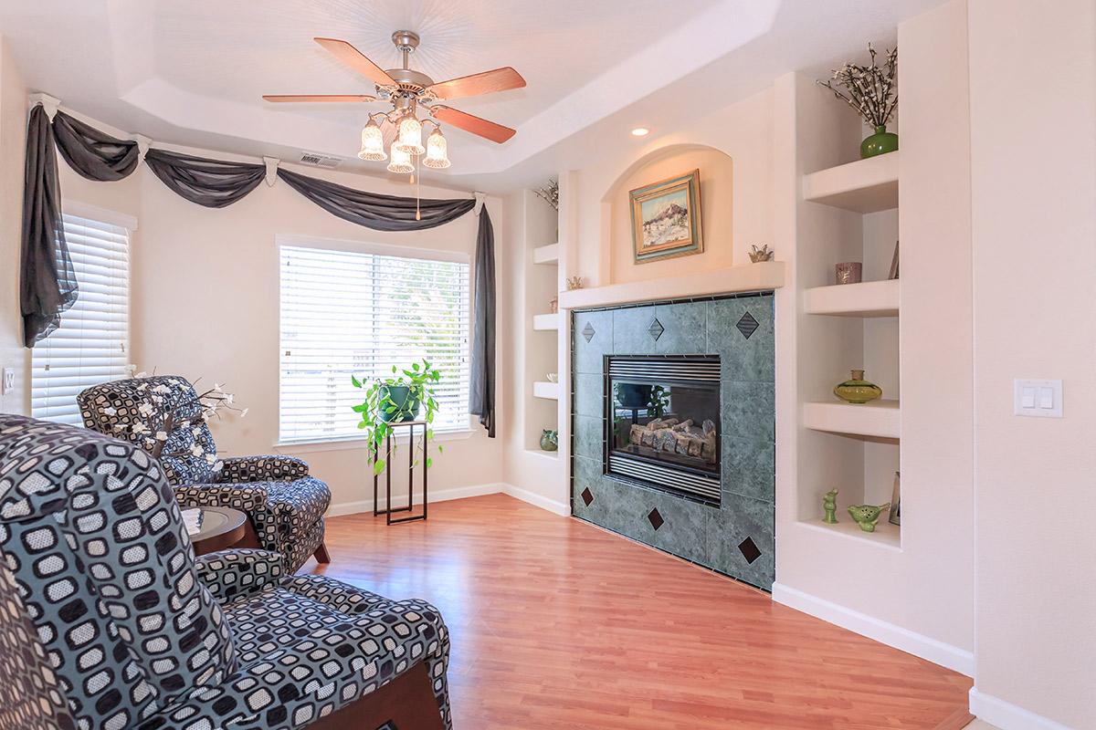 a living room filled with furniture and a fireplace