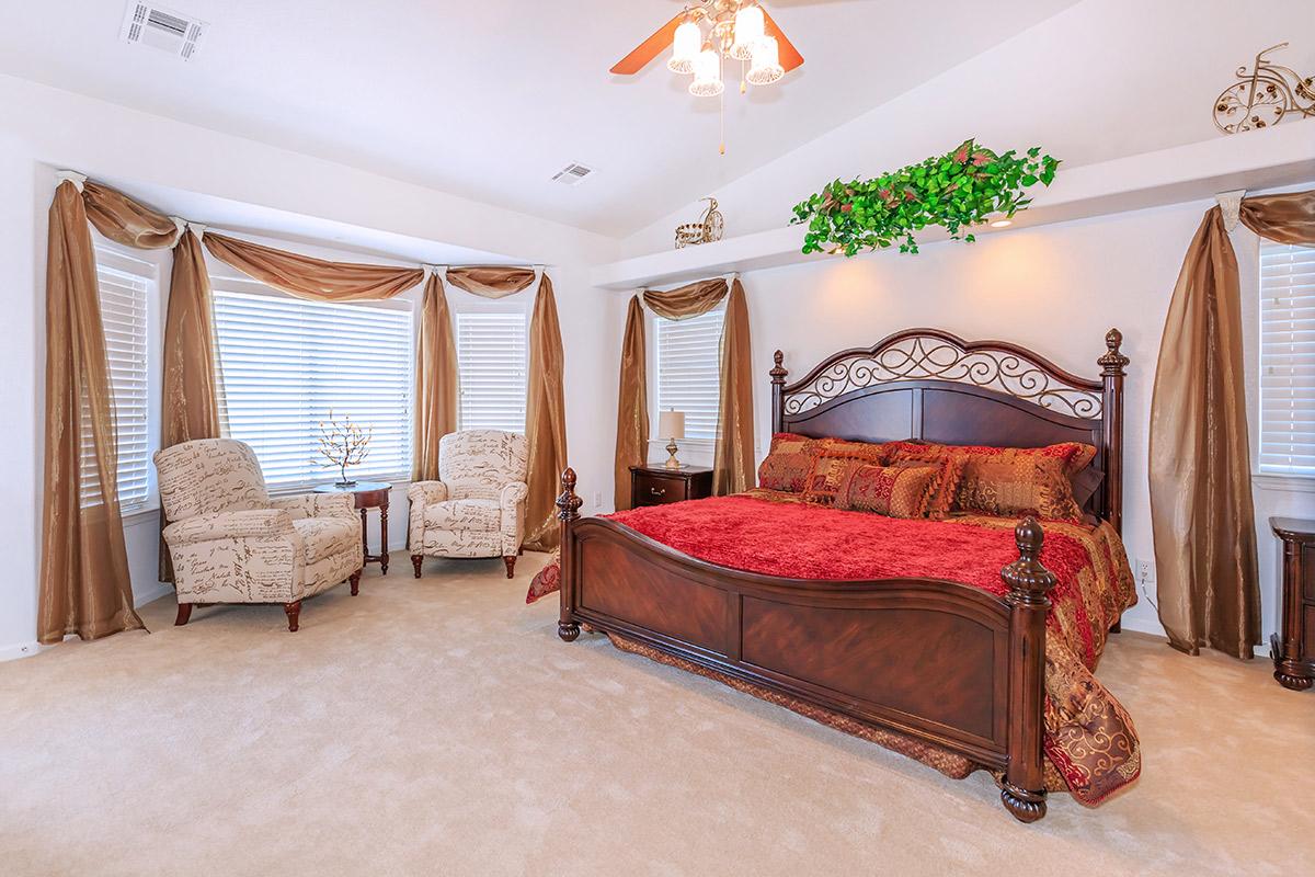 a living room filled with furniture and a bed