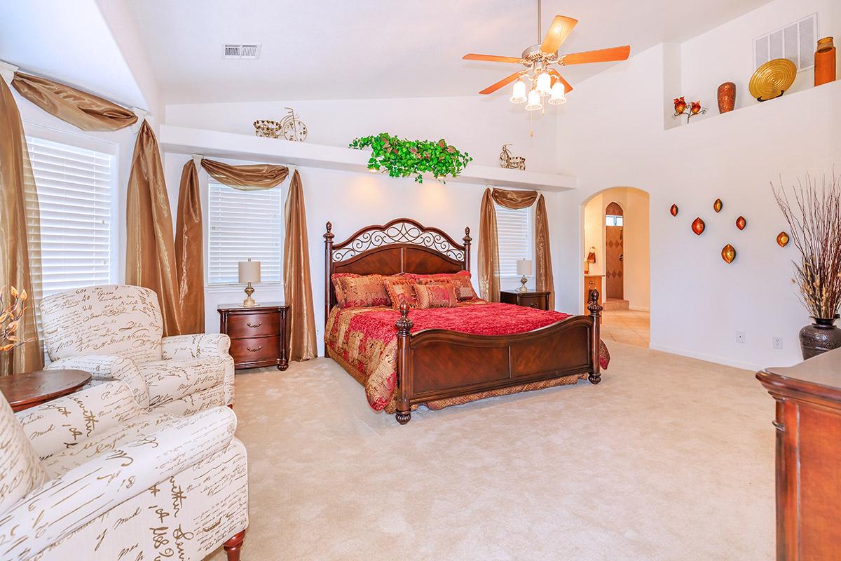 a living room filled with furniture and a bed