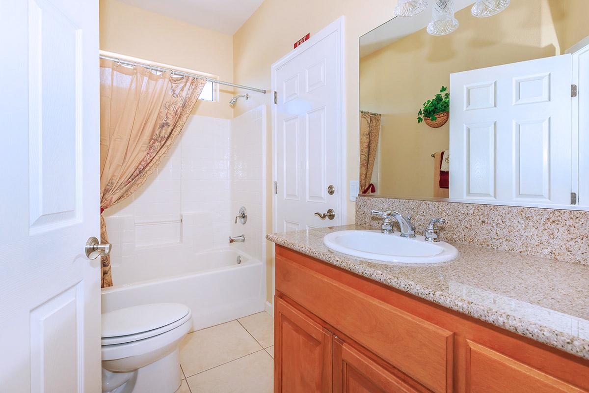 a large white tub next to a sink