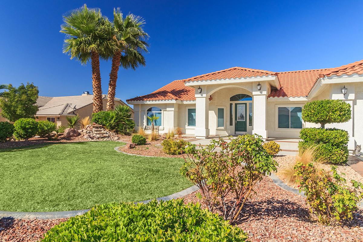 a house with bushes in front of a building