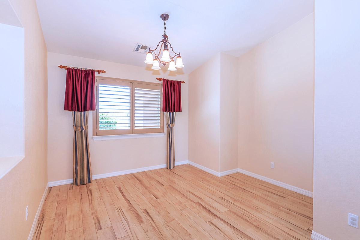 a bedroom with a wooden floor