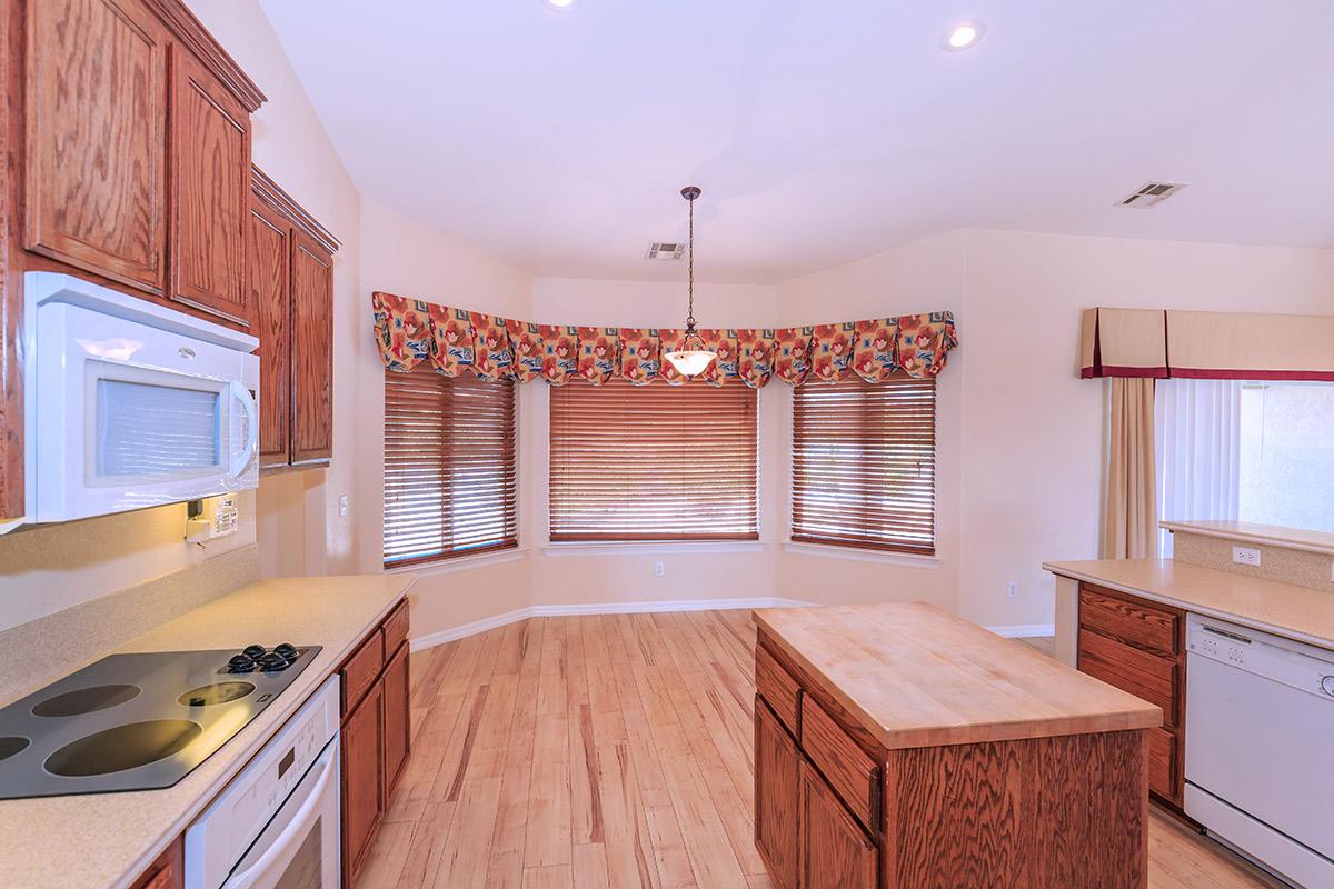 a kitchen with wooden cabinets in a room