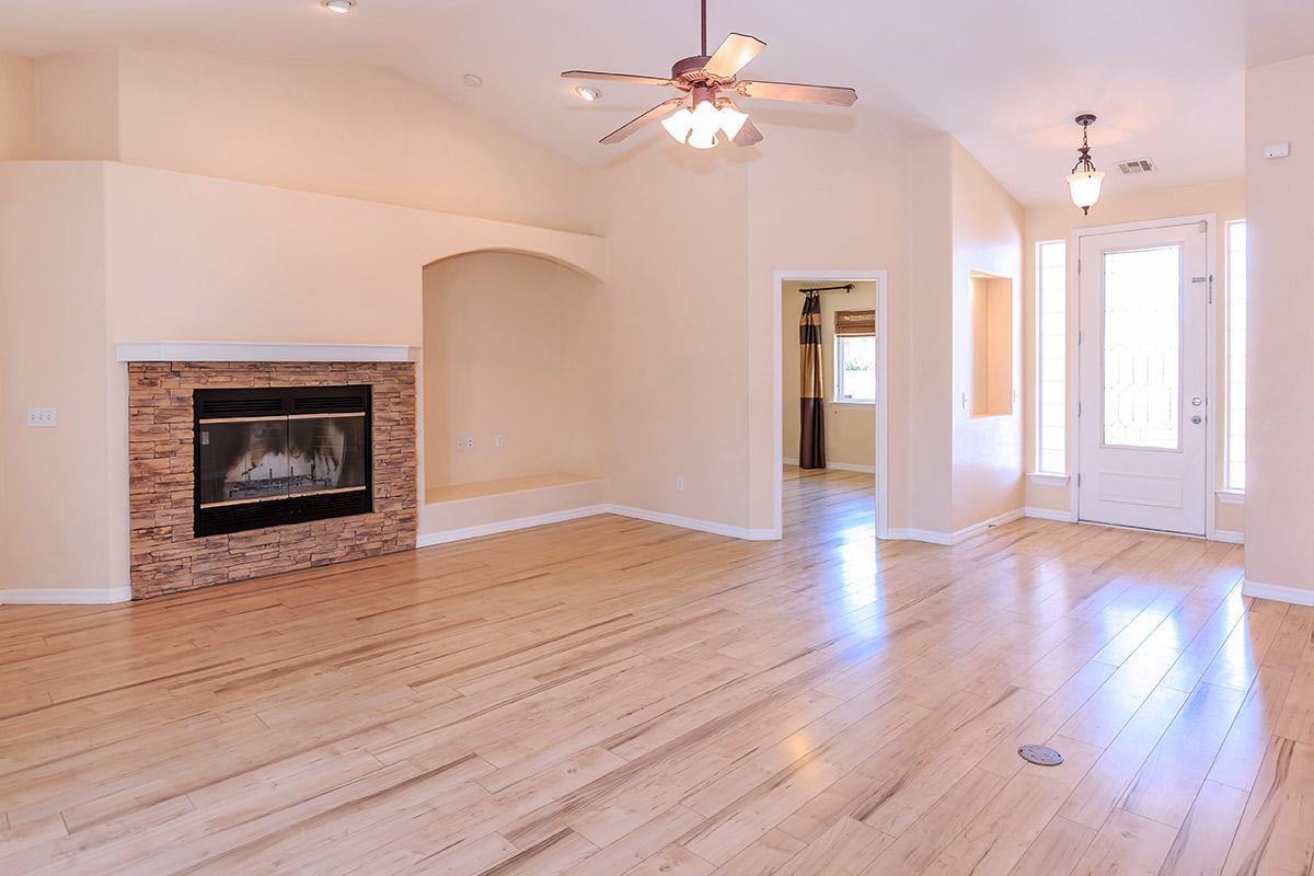 a view of a hard wood floor next to a fireplace