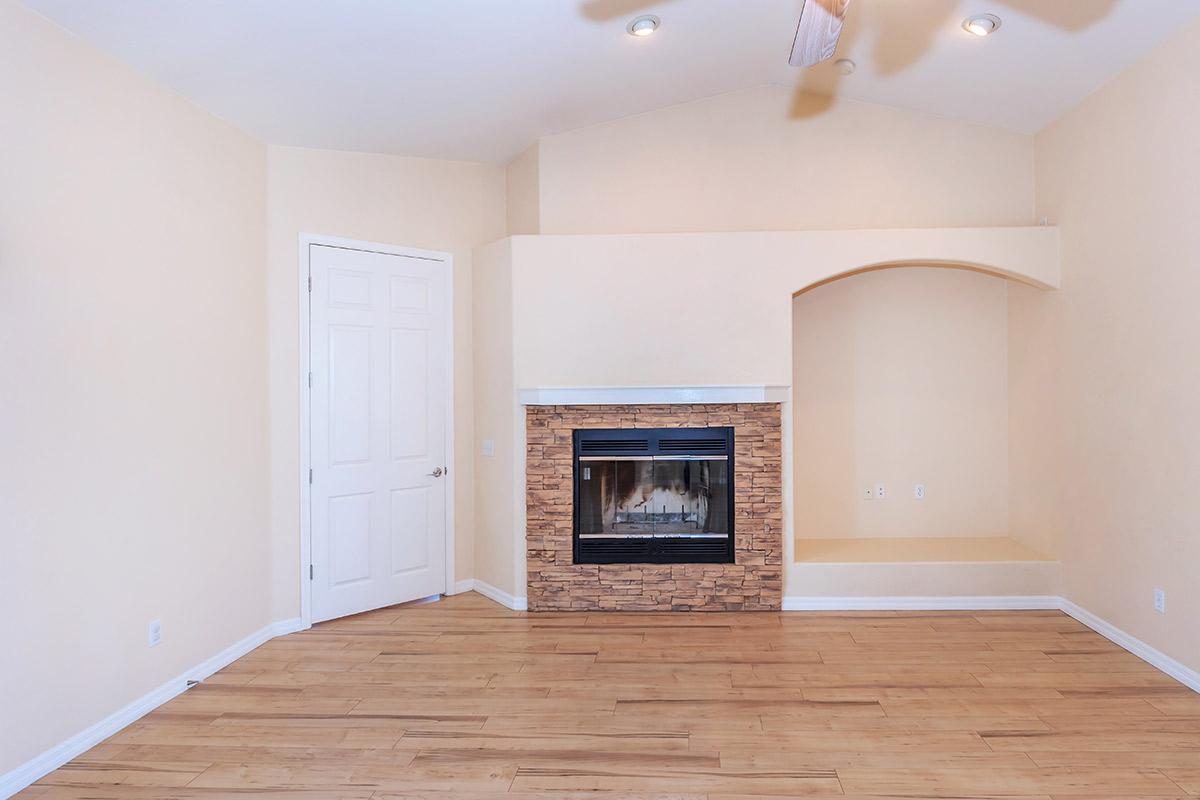 a close up of a hard wood floor next to a fireplace