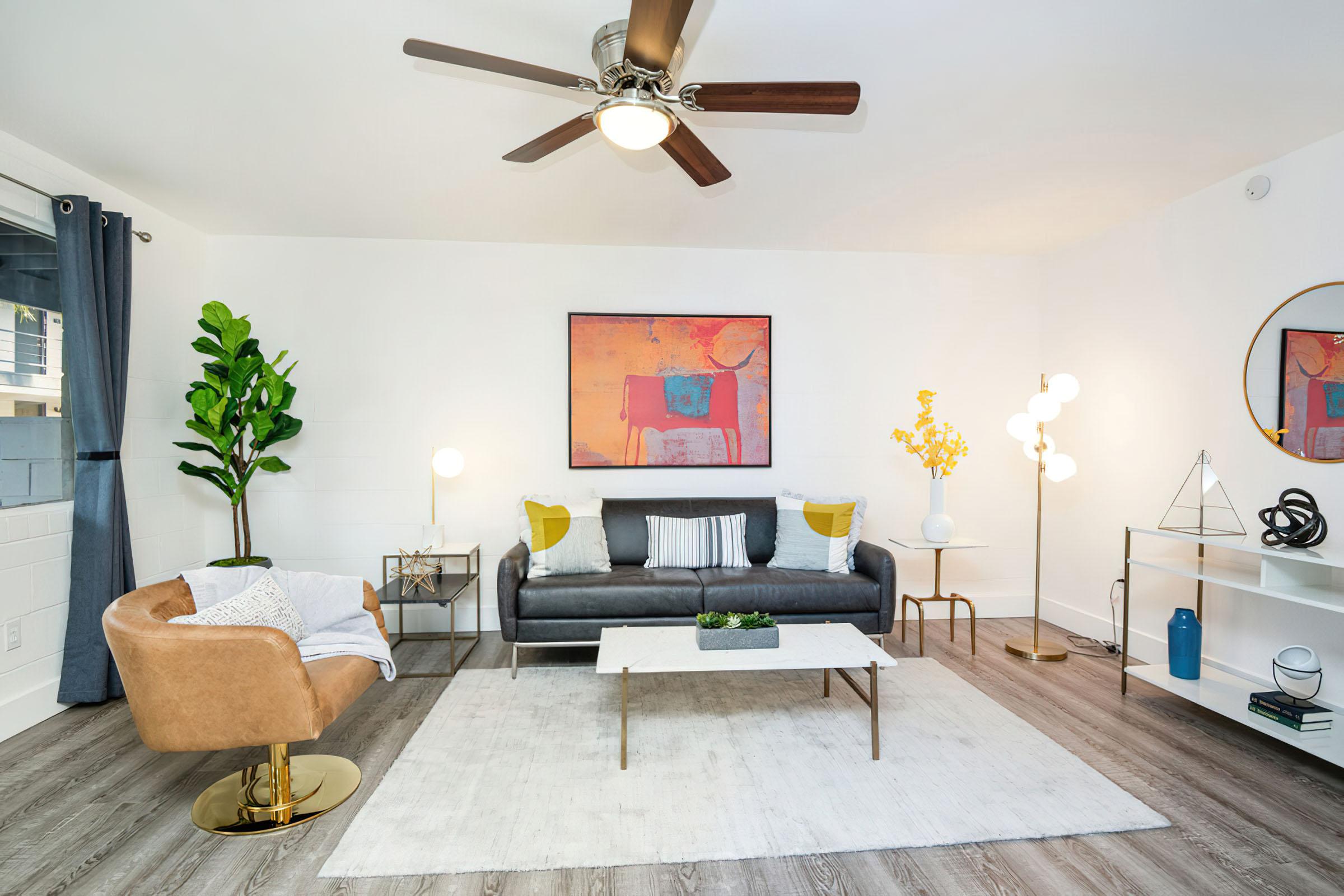 a living room filled with furniture and a flat screen tv