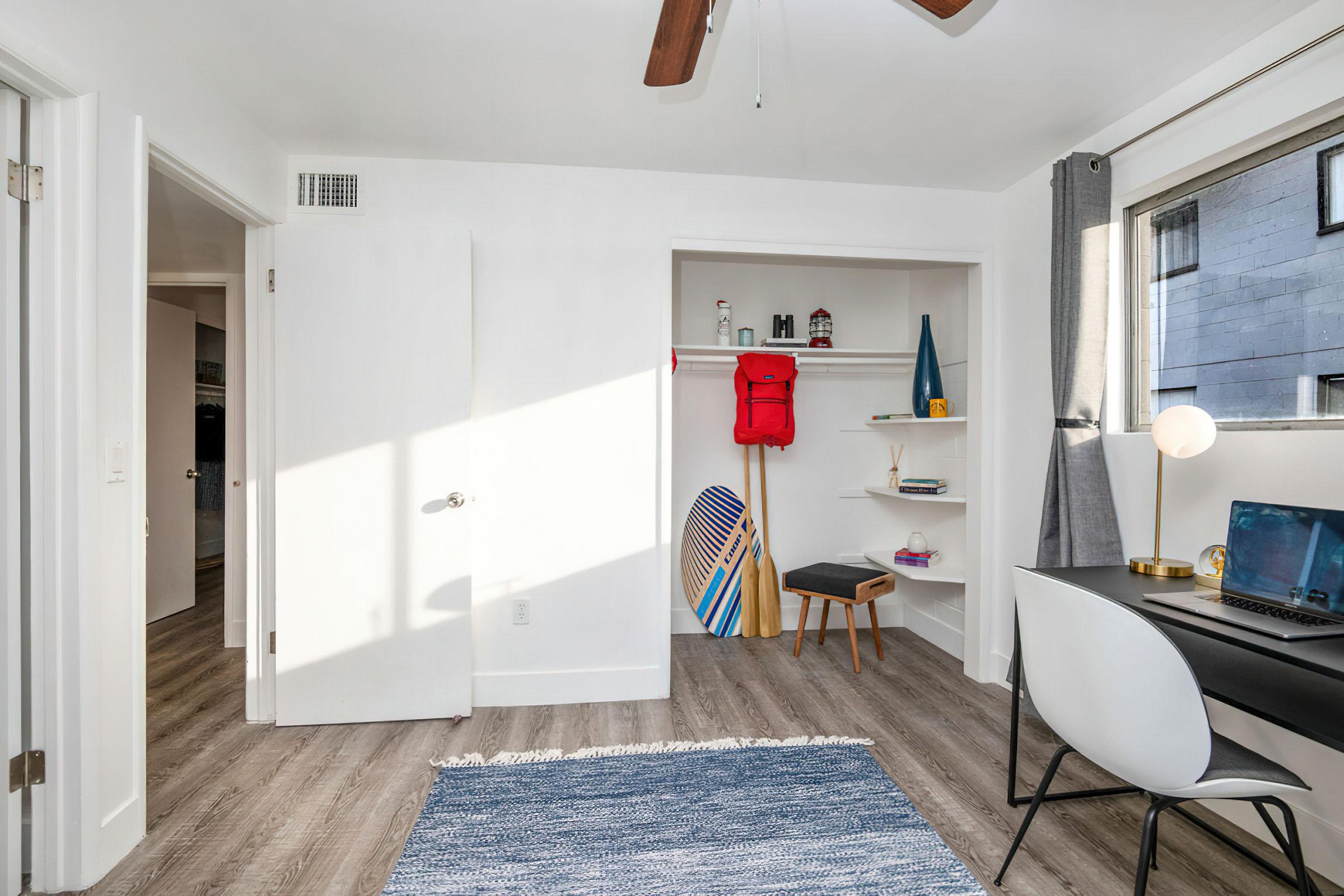 a living room filled with furniture and a refrigerator