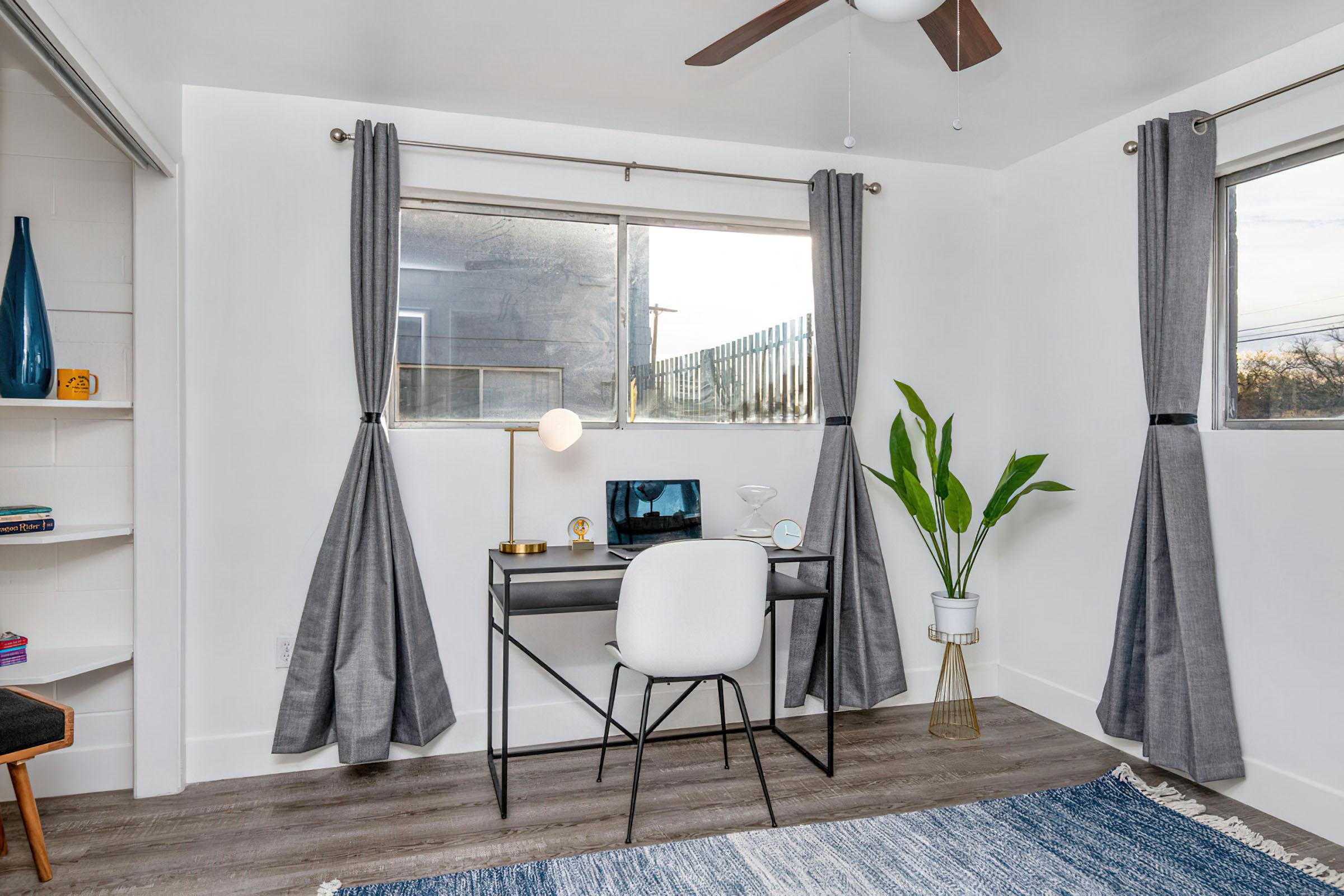 a living room filled with furniture and a large window